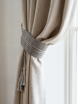 Off white curtain with a decorative ashline tieback  by lifencolors in a living room setting