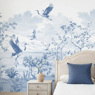 Side view of the Avian Garden wallpaper installed in a bedroom, featuring a scenic blue and white landscape.