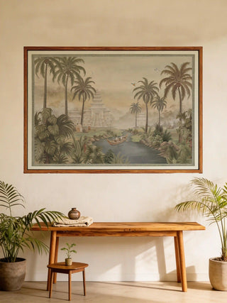 Bali wall art framed in natural wood styled above a rustic wooden bench with indoor palm plants.