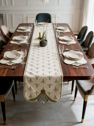 The Barg table mats in Sage & Teal set beneath dinnerware at each place setting alongside the matching Barg table runner.