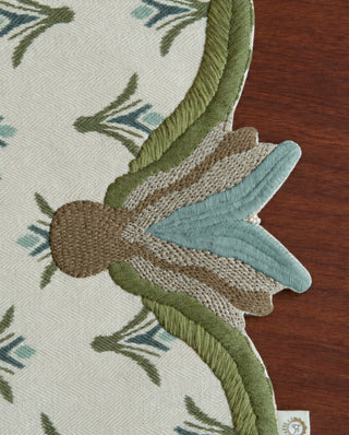 A detailed close-up of the Barg table runner in Sage & Teal highlighting the couched tassel end and pearl bead drop.