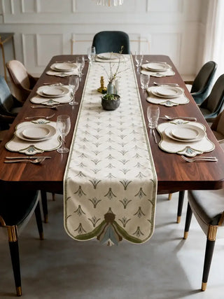 The Barg table runner in Sage & Teal running the length of a formal dining table set with matching scalloped placemats and white dinnerware.
