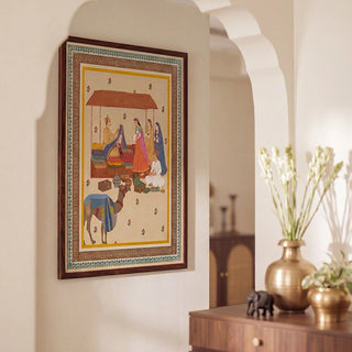Bazar Heritage wall art in a dark walnut frame hung within a white arched niche above a walnut console styled with brass vases, a small elephant figurine, and fresh white flowers in an Indian heritage foyer