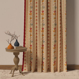 The Bela Fringes curtain, showcasing its vibrant, floral-and-stripe pattern with a bold red fringe border.