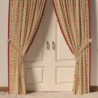 The Bela Fringes curtain hanging in front of a door, showing how its vibrant colors and fringe add a lively touch to the room.