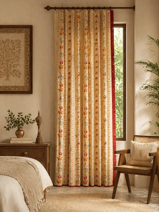 Bela Indian design curtain with floral pattern in a room with a wooden chair and plant.