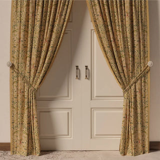 The Bird Tapestry Fringes curtain in a room, hanging in front of a door, showing how the classic pattern adds sophistication to the space.