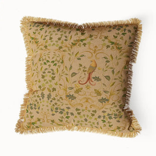 "Bird Tapestry Fringes" cushion cover featuring an intricate green and yellow leaf pattern with a central bird motif on a light background, edged with a textured fringe.