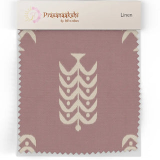 Close-up linen swatch of the Bloomark upholstery fabric in dusty rose, showing the ivory ikat chevron motif and herringbone weave texture.