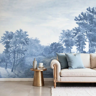 View of the blue misty forest landscape wallpaper behind a sofa, showing a tranquil atmosphere.