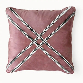 full front view of the blush cross braided cushion showcasing the bold 'X' design