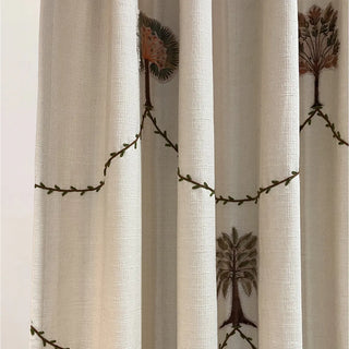 Detailed view of Botanical Bliss Curtain highlighting the stitched vine-like lines and brown botanical elements on light beige background fabric.