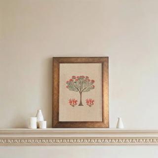 A framed Botanical Bliss Wall Art featuring a delicate tree with red blossoms, displayed on a neutral wall above a decorative shelf.