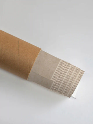 Premium protective packaging tube showing the rolled Britannia Oasis art print and its geometric border detail.