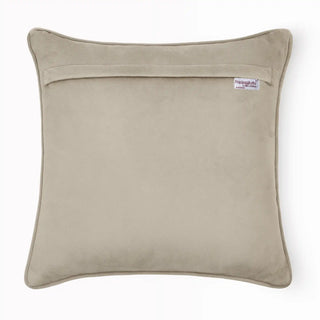 Solid beige velvet back of the Cattitude Courtyard cushion cover showing the brand label.