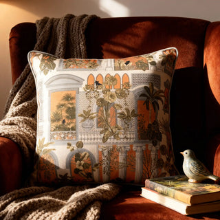 he Cattitude cushion cover styled on a rust-colored velvet armchair in a warm, sunlit living room.