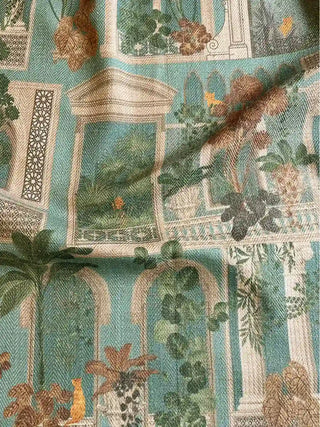 A draped view of the Cattitude teal fabric showing the soft textile weave and the detailed architectural and feline print.