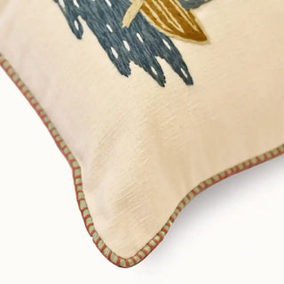 A detailed corner close-up highlighting the heavy raw linen fabric slubs and the custom red and green striped piping trim of the Celestial Veil cushion.
