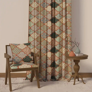 The Chaap Pipin curtain styled in a room with a chair and side table, demonstrating its full length and cozy, handcrafted feel.
