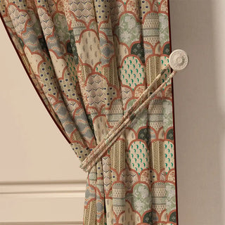 A close-up of the Chaap Pipin curtain tied back, highlighting its neat piped edge and the different patterns within the scalloped shapes.
