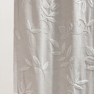 Close-up of Chandni Curtain fabric showing intricate leaf-patterned weave in a shimmering finish.