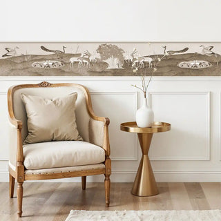 The Chandni Van sepia wall border styled above white wall paneling with a neutral bench and cushion.