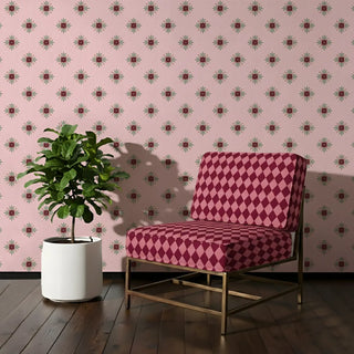Chair upholstered in Chausar Fabric featuring large maroon and pink diamond patterns against a soft floral wallpaper.