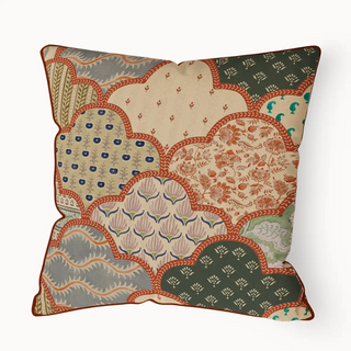 Chhap Pipin cushion cover with a scalloped patchwork design in earthy tones of beige, green, and terracotta, featuring various block-print inspired patterns.