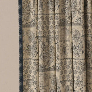 A detailed shot of the Chhaya Fringes curtain fabric, showing the intricate, subtle geometric pattern and its distinct bordered panels.