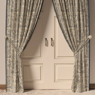 The Chhaya Fringes curtain in a room, hanging in front of a door, showing how the panels and fringe frame the space.