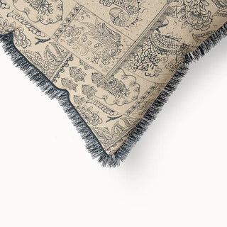 A close-up view of the "Chhaya Fringes" cushion cover, highlighting the intricate block-print patterns and the texture of the dark gray fringe.
