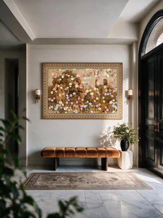 The Chinoiserie Gardens of Antiquity wall art framed above a velvet bench in a marble-floored entryway.