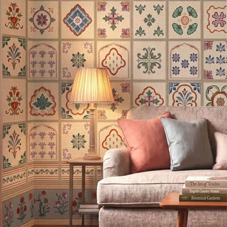 The Chitrangan heritage fresco tile wallpaper styled as an elegant accent wall behind a plush cream living room sofa view-livingroom 