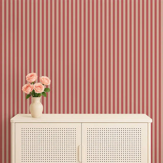 Red & cream striped wallpaper styled behind a cream cabinet with a vase of pink roses, adding warmth and charm.