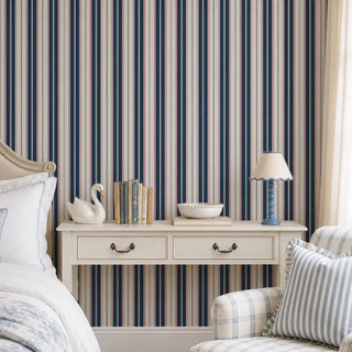 Classic Navy Pinstripe wallpaper behind a floating nightstand styled with books and a ceramic swan.