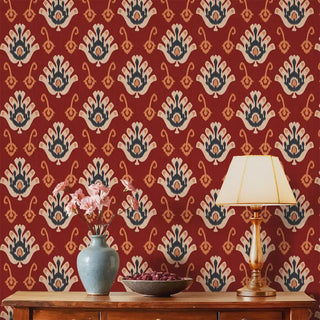 A room view of the Classic Nomad Wallpaper in red, showcasing the repeating symmetrical motifs across the wall.