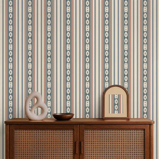 The striped wallpaper styled behind a wooden console with minimal décor, giving a warm and elegant feel.