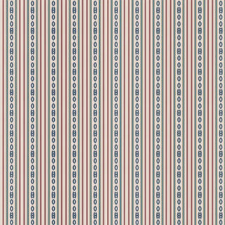 A full wall covered with repeating vertical stripes in red, blue, and cream tones.