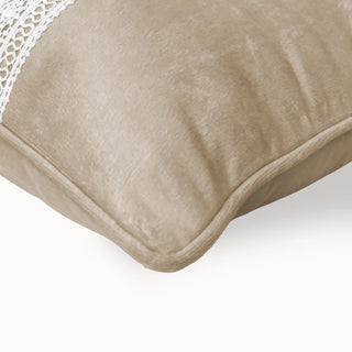 Detailed view of the cushion corner highlighting the white intricate lace embroidery.