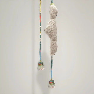 Close-up shot of the Cloudloom Tieback hanging, showing the central embroidered cloud detail and the multi-hued cords and tassels.