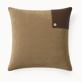 front view of Corner Saddle Cushion, its modern, minimalist design on a rich brown velvet fabric.