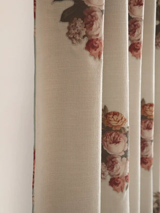 A macro view of the custom Cotswold Rose linen drapery showcasing the full-flowing vertical fabric folds and translucent weave.