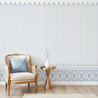 Court of Petals blue and white striped wallpaper with floral borders, installed in an elegant sitting room with wainscoting.