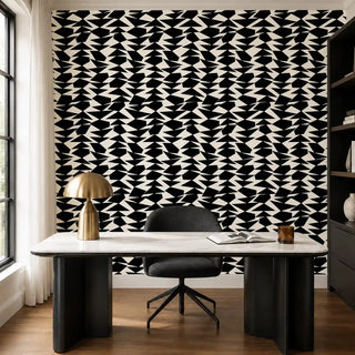 The Couture Mosaic black off white wallpaper installed behind a marble desk and black bookshelf in a home office