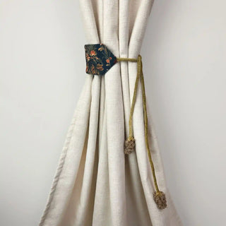Rustic Flora Handcrafted Curtain Holdback secured on a cream curtain, showcasing the dramatic contrast of the dark floral panel.
