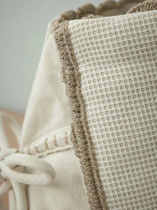 Macro detail shot of Deep Lore jug cover highlighting the crocheted edge trim and textured waffle weave fabric.
