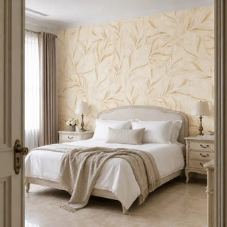 The Desert Solstice wallpaper in Ivory & Gold installed on a feature wall in a bedroom behind an upholstered bed frame and matching nightstands. view-bedroom