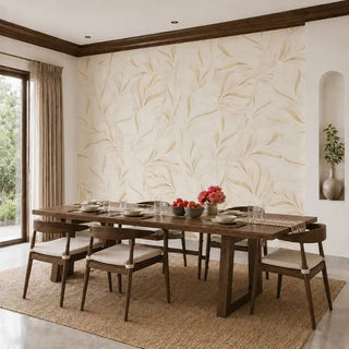 The Desert Solstice wallpaper in Ivory & Gold installed on a feature wall in a dining room behind a wooden dining table set for a meal. view-dining