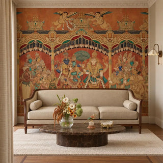 The Deva Sabha wallpaper in Terracotta & Gold behind a cream sofa and an oval marble coffee table in a living room.