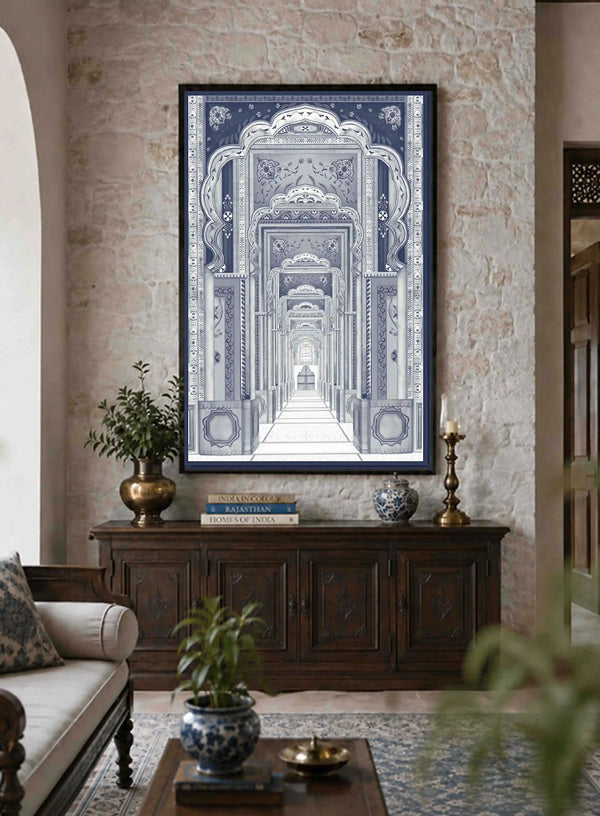 Framed Dilli Darbar wall art above a wooden console beside a cream sofa in a warm stone-walled living room